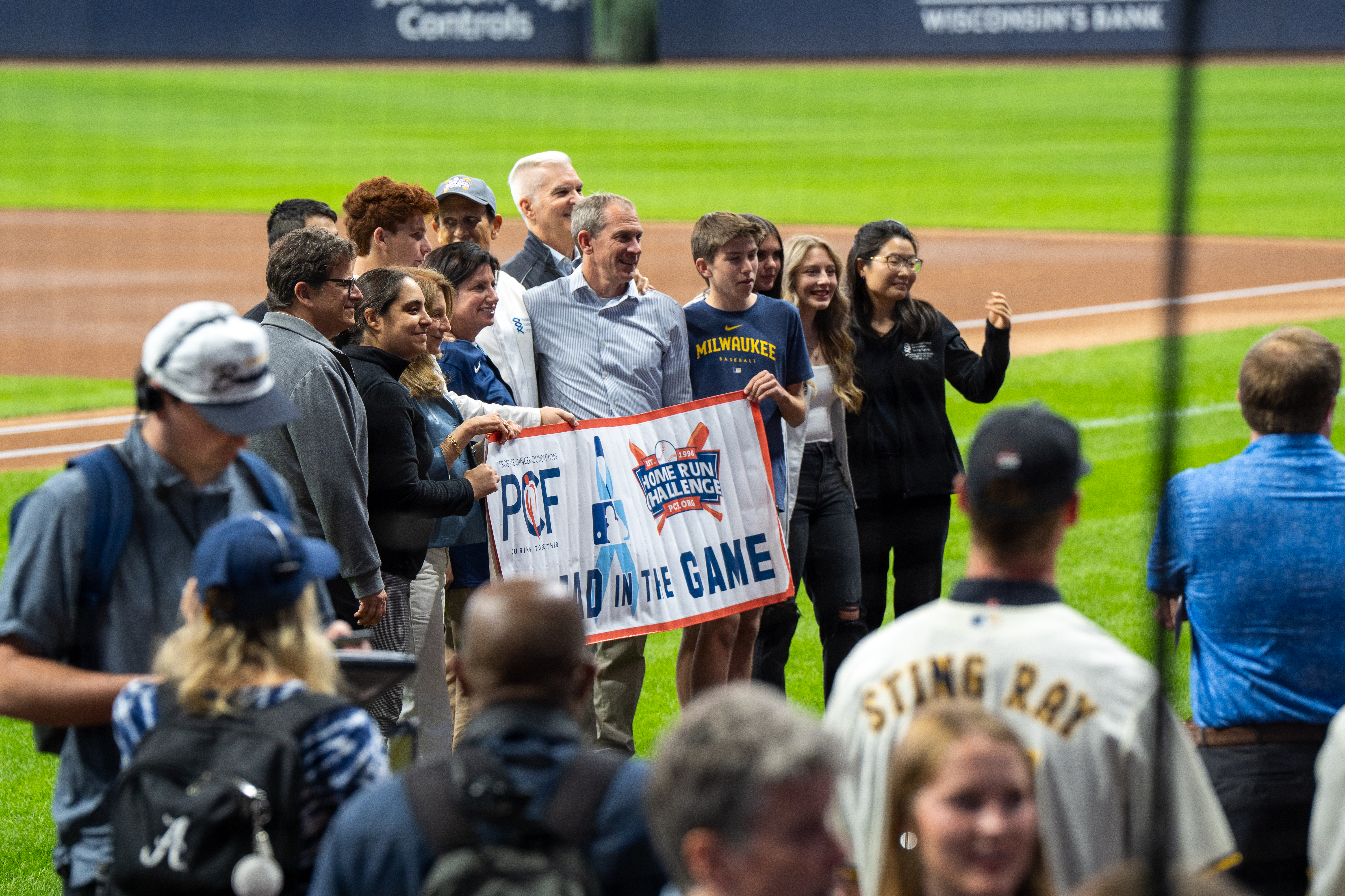 Team members showcasing Prostate Cancer Foundation promotional materials and QR codes